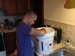 Tim cleans the primary fermenter before sanitizing.