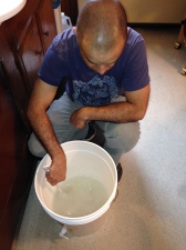 Tim mixes the bentonite with hot water in the primary fermenter