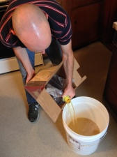 Kevin adds the concentrate to the sanitized primary fermenter.