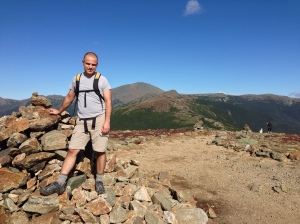 Tim at the 4800 foot summit of Eisenhower in the southern Presidentials of NH's White Mountain National Forest.  Mt. Washington is at his left shoulder.